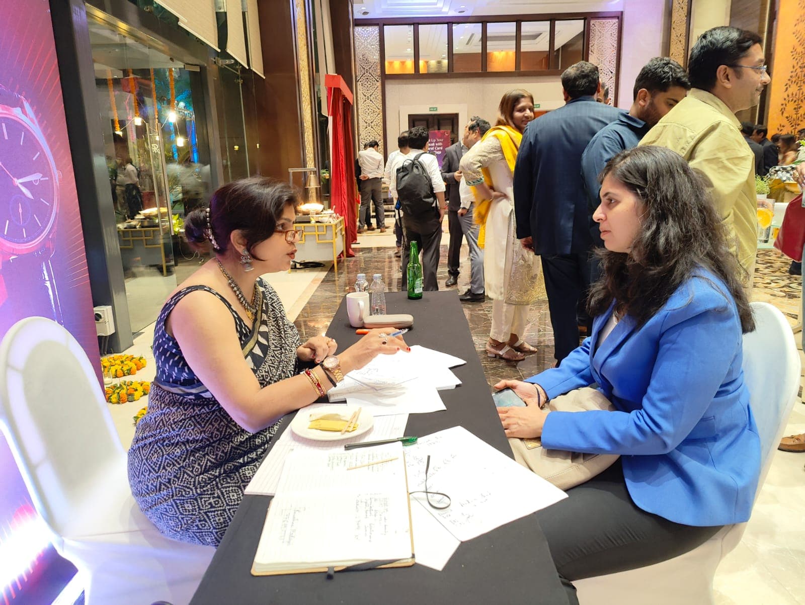 Rruchi Modayi reading a signature for a client at a live event