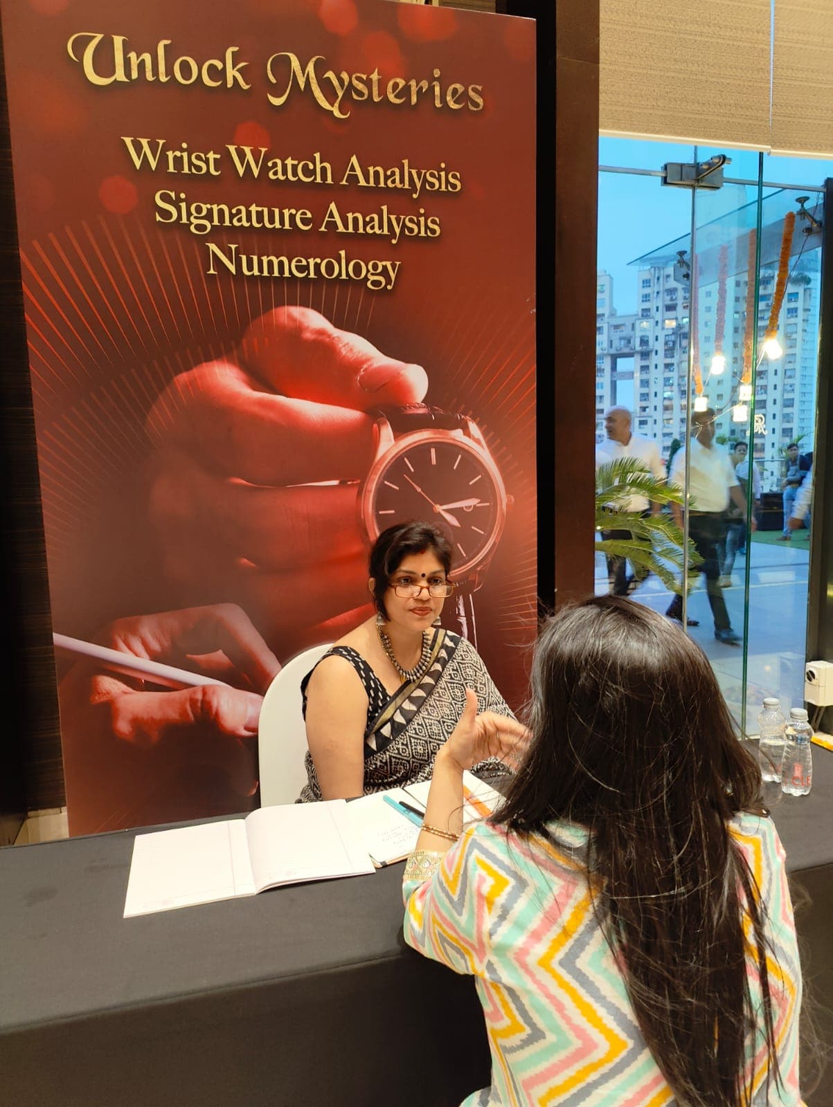 Rruchi Modayi consulting a client at her Unlock Mysteries event desk